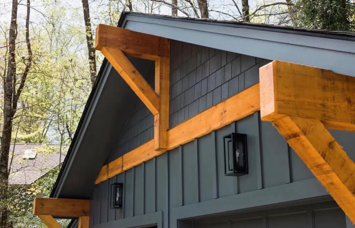 Timber frame pergola with metal roof, wooden beams and charcoal siding
