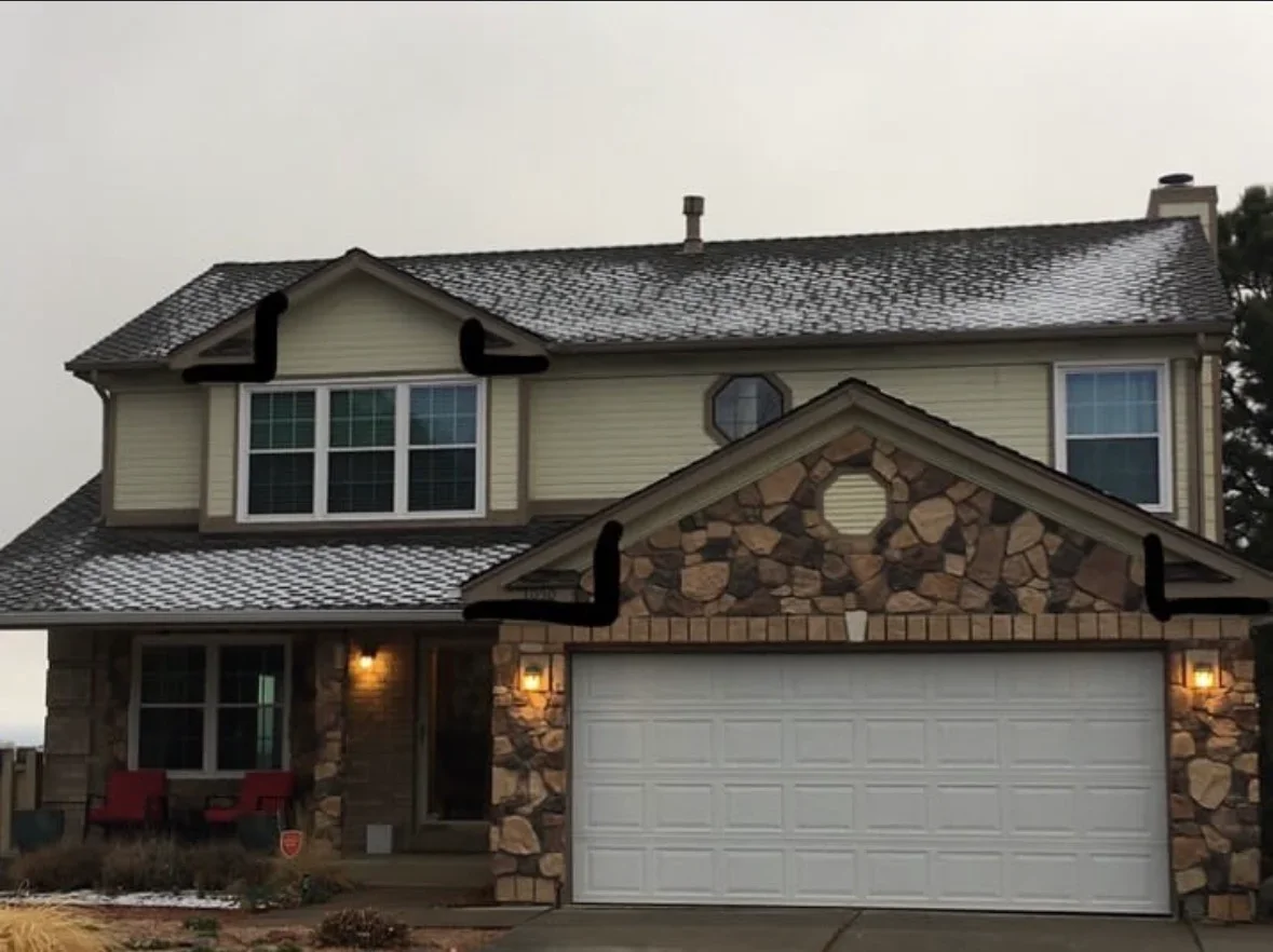 Two-story home with new asphalt shingle roof, vinyl siding, and stone veneer facade