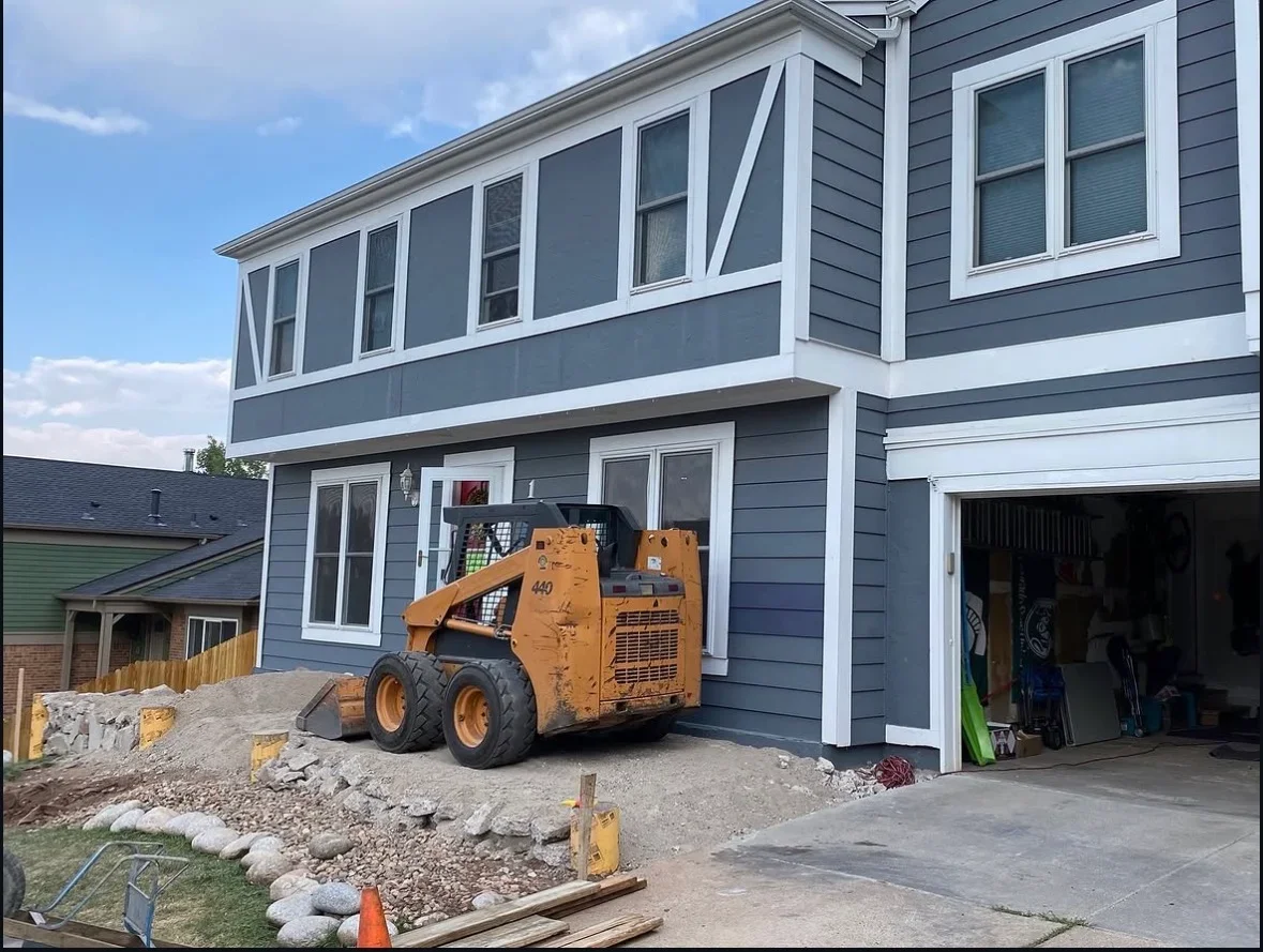Two-story home with charcoal gray fiber cement siding, white trim, and new multi-pane windows