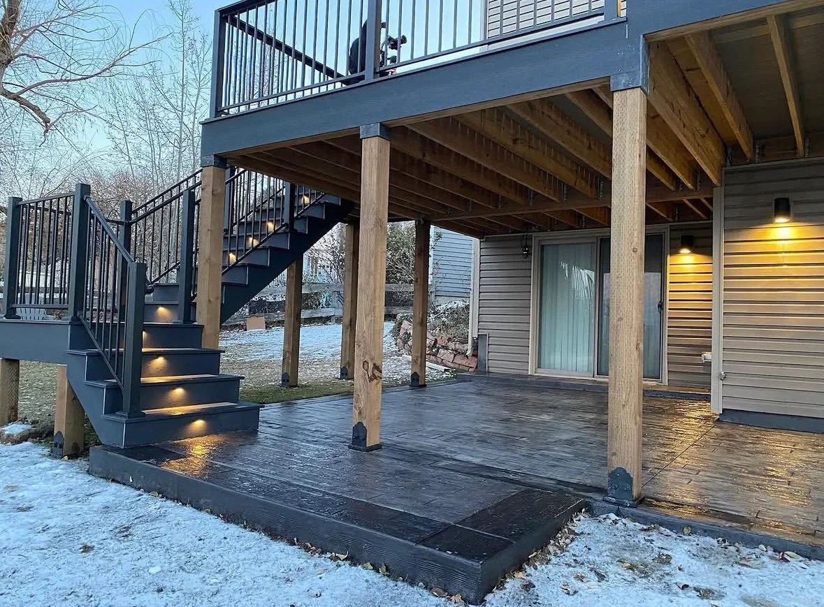 Two-level composite deck with steel stairs, metal railings, and wood beam structure