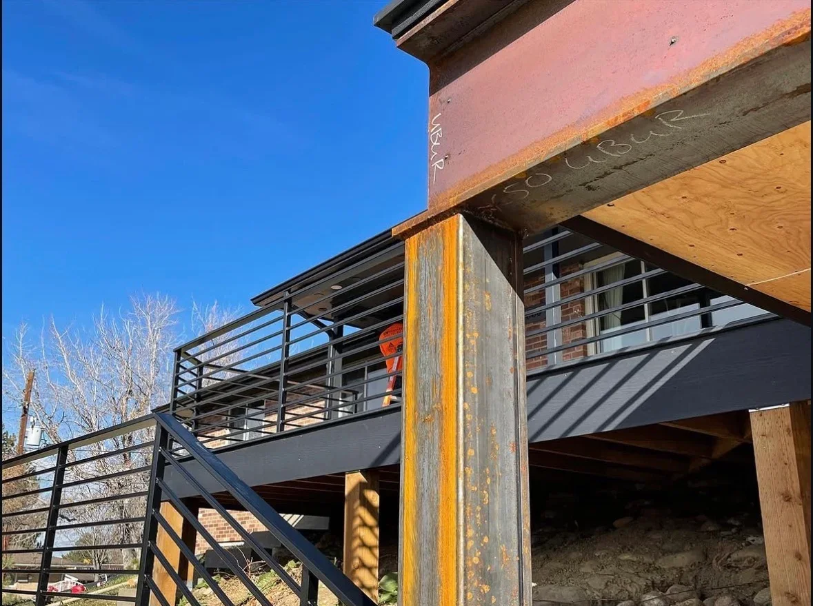 Multi-level deck with steel railings, composite decking, and metal roof structure