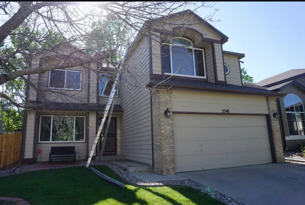 Two-story home with new fiber cement siding, updated windows, and restored gable details