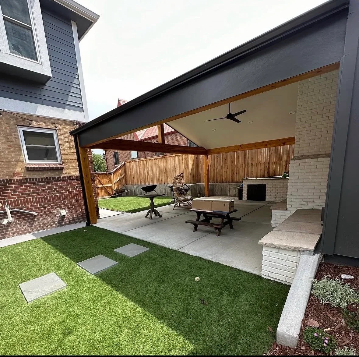Covered patio with composite decking, steel frame, ceiling fan, and concrete seating area