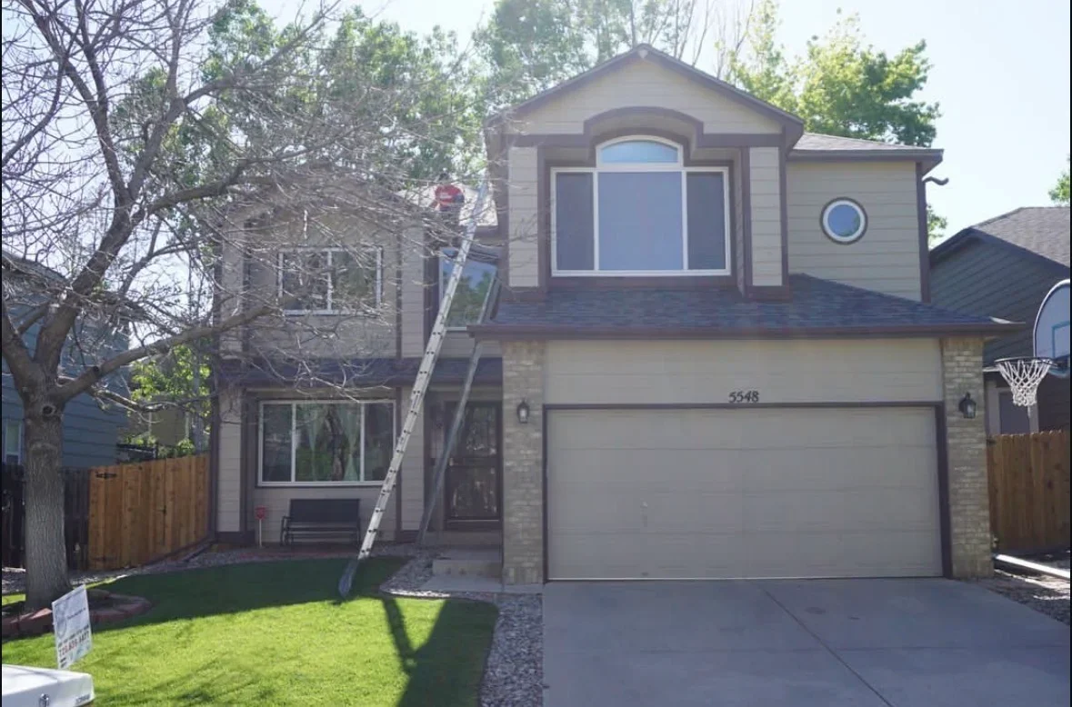 Two-story home with new fiber cement siding, large windows, and updated exterior trim