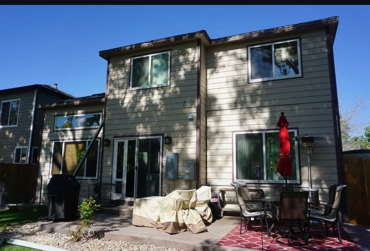 Composite deck and patio with outdoor seating area adjacent to modern fiber cement siding home