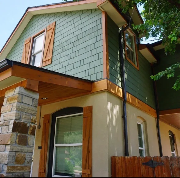 A Littleton, Colorado home with newly installed lap siding, clean corner boards, and freshly detailed window trim. The exterior shows a complete installation with consistent panel reveals across the front elevation.