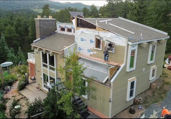 A Littleton home exterior showing freshly repaired siding panels with flush joints and consistent lap spacing after hail and storm damage. The repaired sections blend with the surrounding exterior on a residential property in the Littleton, Colorado area.